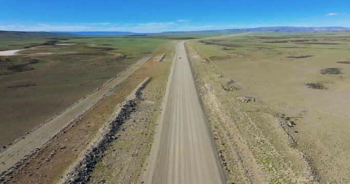 4K video, slow forward drone flight over unpaved road (Ruta 40) on the desolate pampas in Patagonia, southern Argentina