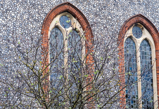 Tree in front of stained glass windows of an Anglo Saxon Church