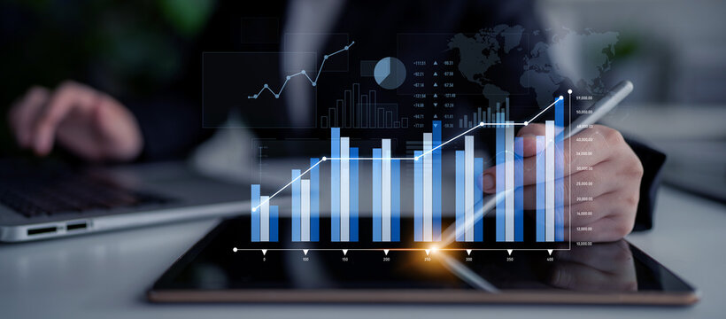 A business professional is using a tablet to analyze financial data displayed through interactive graphs and charts, illustrating market trends and success. Scalp