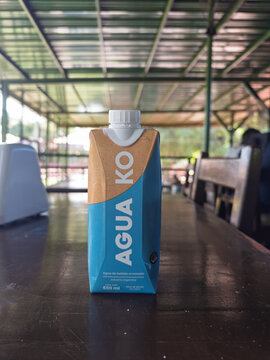 Santiago, Chile, March 15, 2026, Agua KO, carton, 0,5 l, carton of mineral water on a wooden table in an outdoor restaurant