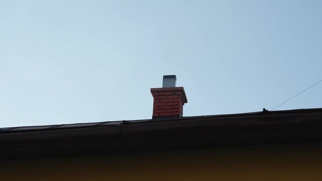 Minimal view of roof edge silhouette against clear blue sky. Simple architectural composition with clean lines and copy space.