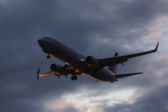 Passenger airplane arriving at Anchorage airport during sunset. Anchorage, Alaska, May 2022