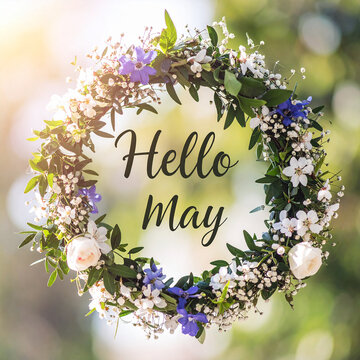 Beautiful floral wreath made of spring flowers and greenery with text HELLO MAY in center, concept of spring arrival, renewal and fresh beginnings