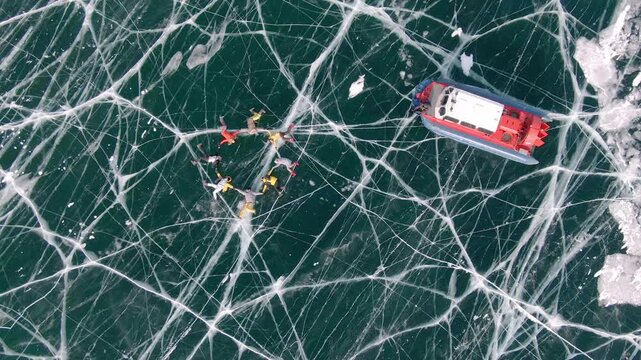A hovercraft circles around people on the textured snow-covered ice of Icy Lake Baikal
