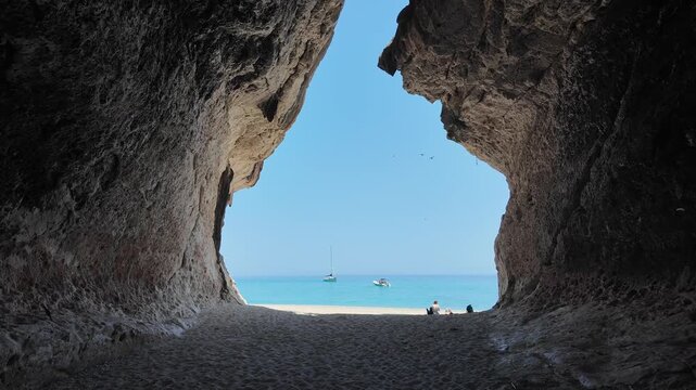 Secluded cave with ocean view, perfect for exploration and adventure visuals, Cala luna, Italy