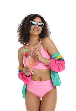 Woman with cocktail wearing stylish swimsuit and sunglasses on white background