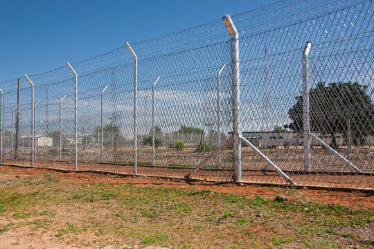 High Security Chain Link Fence with Razor Wire stands before a compound