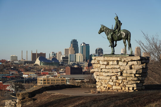 Kansas City skyline with The Scout statue in the foreground, depicting a Sioux rider on horseback. Kansas City, Missouri, February 2023