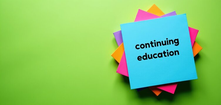 Brightly colored paper stack with text continuing education. Concept for lifelong learning, career development and skill acquisition. Useful for articles, presentations and websites about courses.