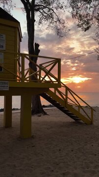 Fiery sunset over the lifeguard station stairs at Folkestone Marine Park, west coast Barbados Caribbean