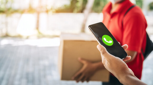 Delivery man using smartphone to coordinate package drop-off