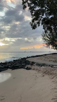 Sunset over distant yachts at Folkestone Marine Park, Holetown Barbados
