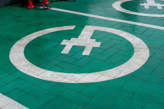 Electric Vehicle Charging Station Markings on Floor in a Parking Area During Daytime