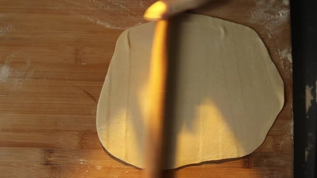 Female baker preparing dough for homemade pastry