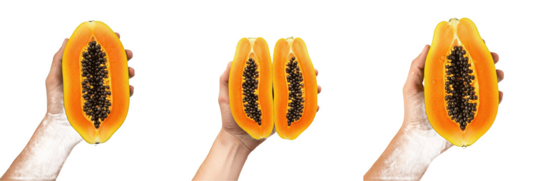 Hand holding a sliced papaya with seeds Carica papaya cut fruit Papaya troceada Papaye coupee tropical snack orange pulp black seeds organic health nutrition enzyme papain farm fresh food