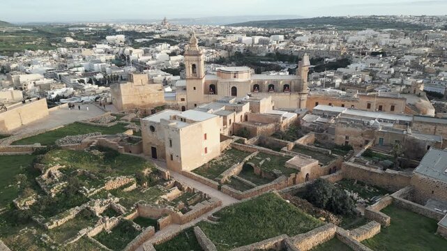 Golden hour aerial view of historic architecture inside the Citadel of Victoria, Gozo, Malta.