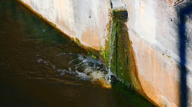 Slow Motion Water Discharge from Concrete Drainage Outfall into Dark Canal with Foam and Algae | Urban Water Pollution and Aging Drainage Infrastructure
