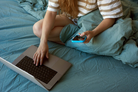 Woman working with laptop and phone 