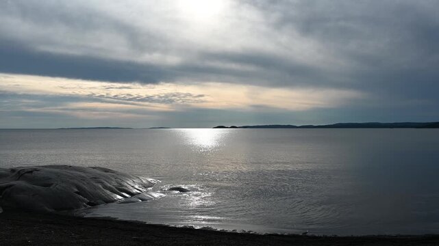 Sunlight Reflection On A Large Lake With Gentle Waves Coming To Shore