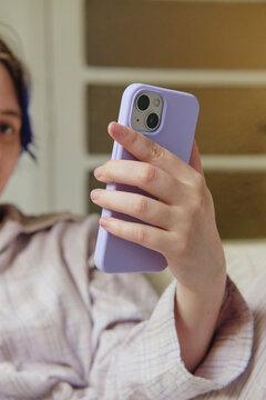 Person looking at their smartphone in pastel colors