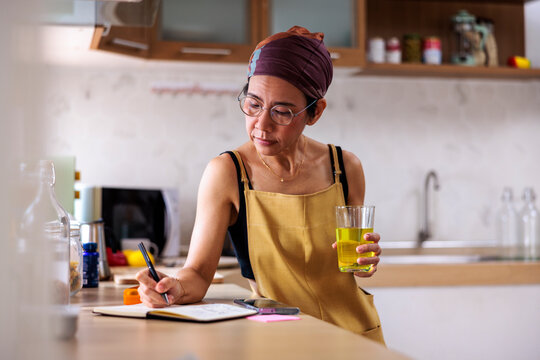 Woman writing reminders for the day ahead