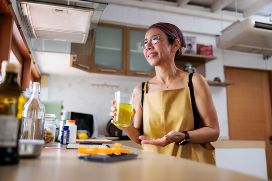 Woman with cancer takes her daily medication