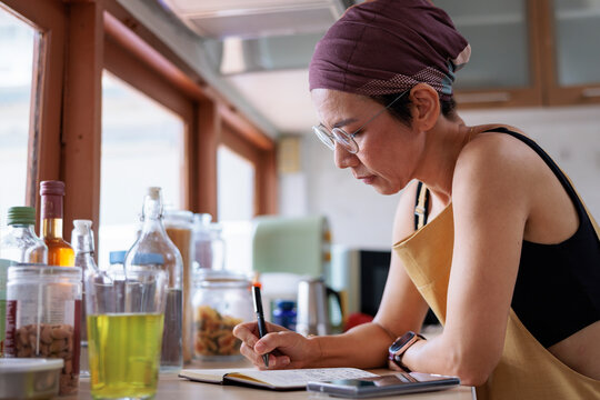 Writer brainstorming in notebook by window