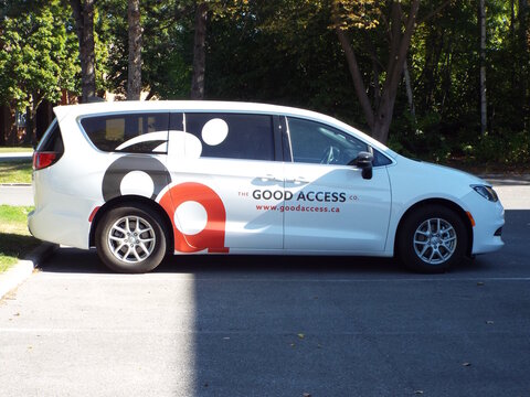 Nepean, Ontario, Canada &ndash; July 27, 2025: A white minivan branded with "The Good Access Co." logo and website is parked in an outdoor parking lot on Antares Dr.
