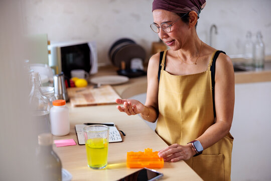 Woman taking medicine and following notes for preparation