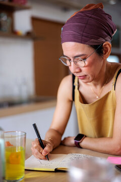 Writer working at home in kitchen