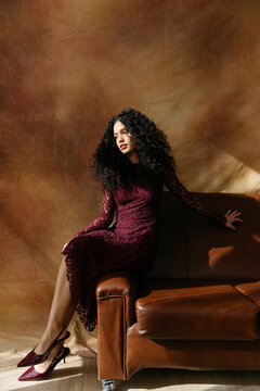 Woman in lace dress on sofa