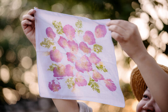 Plant-dyed silk fabric drying in the sun