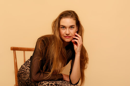 Woman With Long Hair Sitting on a Chair 