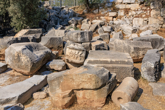 Ancient ruins with carved stones and broken columns in archaeological site