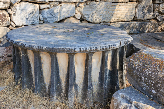 Ancient stone column base in historic ruins with weathered textured surface