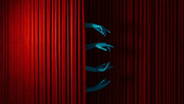 Hands reach out from behind curtains in a theater setting