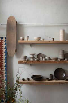 Ceramic Objects on Wooden Shelves in Pottery Studio