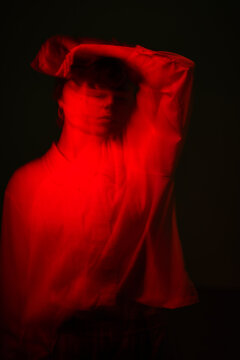 Person moving with light in dark room during night