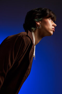 Portrait of a person looking up with a blue background at night