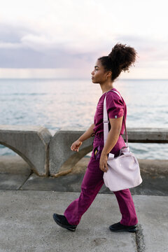 Healthcare Worker Walks Along the Shore 