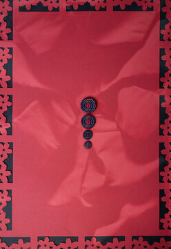 Colorful paper decoration with floral cutouts on a red background