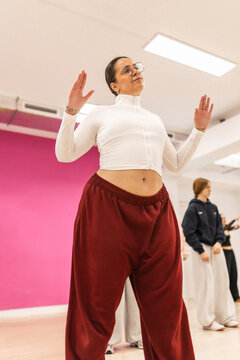 Plus size woman dancing urban choreography in studio