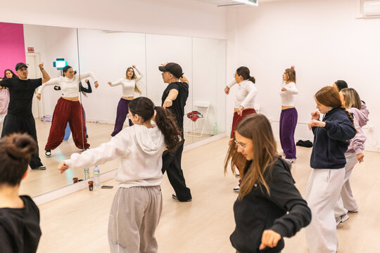 Group of young dancers practicing urban choreography in studio