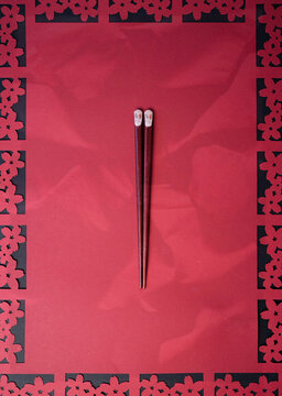 Chopsticks with decorative red background