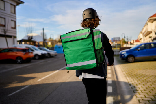 Delivery rider transporting food with large green backpack