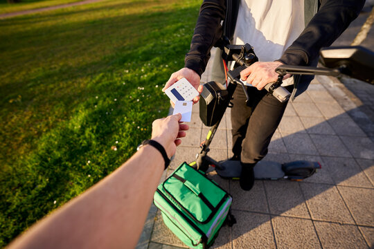 Delivery rider receiving card payment for food order