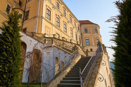 Historic european castle facade with stone staircase and clear sky