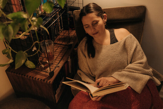 Woman Reading Book in Warm Evening Light