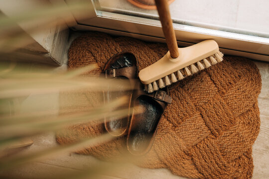 Natural Bristle Floor Brush and Leather Sandals on rug