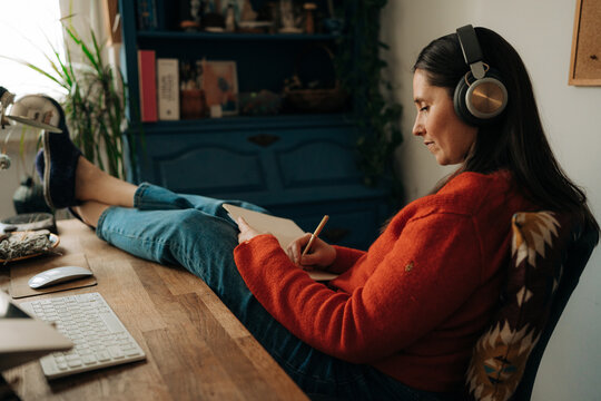 Woman Working and Taking Notes in Home Office
